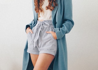 woman in gray blazer and white and black striped dress