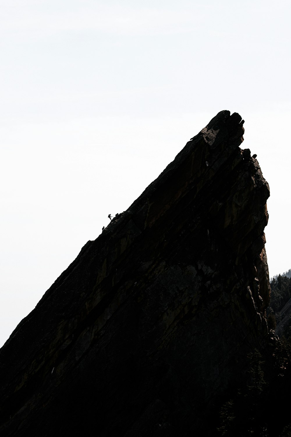 brown rock formation under white sky during daytime