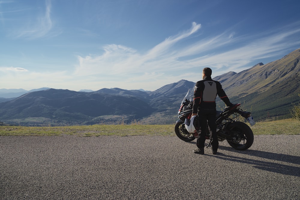 man in black jacket riding motorcycle on road during daytime