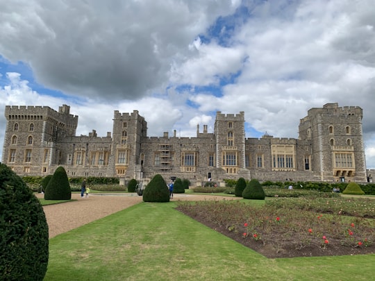 brown concrete building under white clouds and blue sky during daytime in Windsor Castle United Kingdom