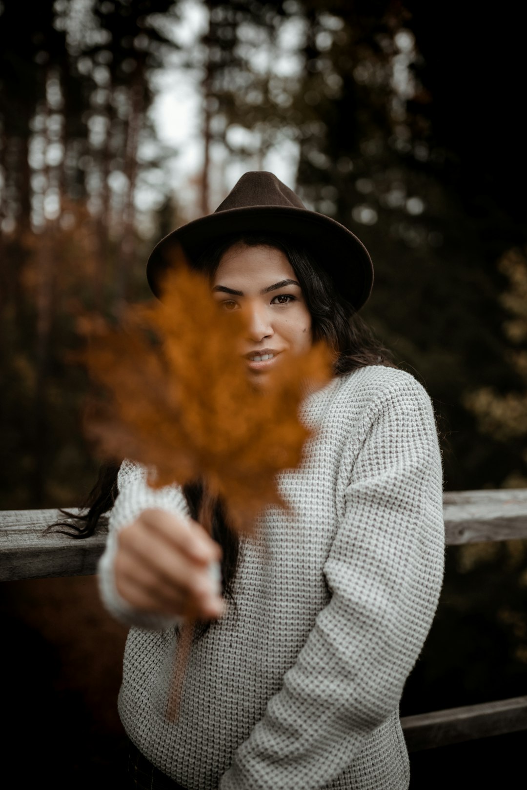 woman in gray long sleeve shirt and black hat