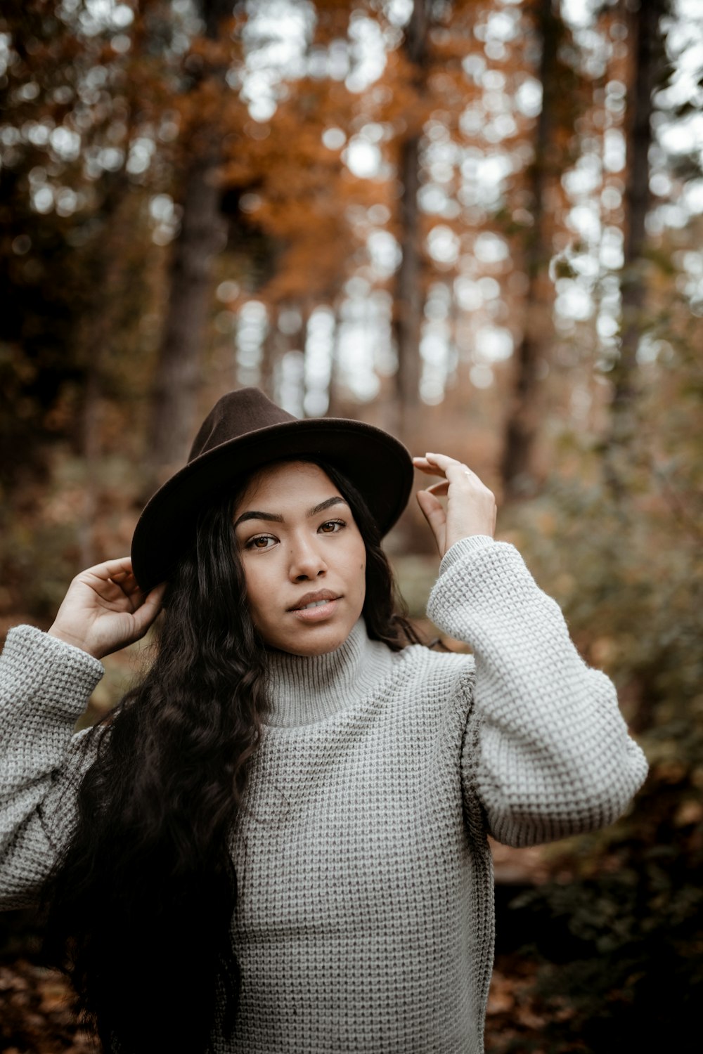 woman in black hat and white sweater