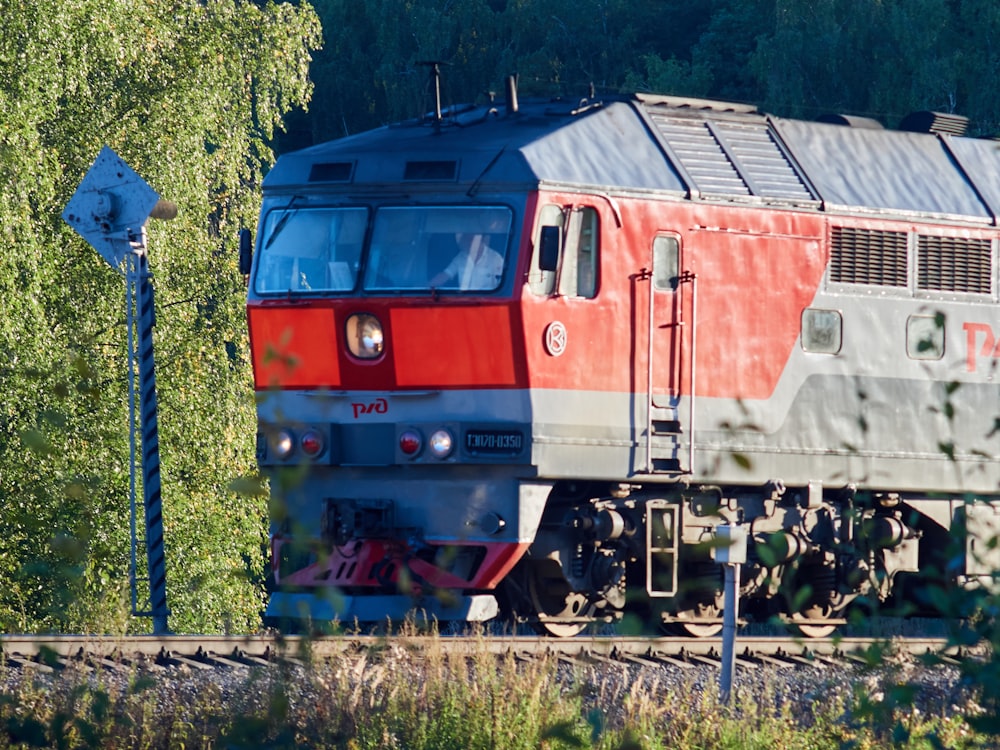 red green and yellow train on rail tracks