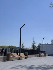 Wide shot of a clean commercial plaza with freshly washed walkways and storefronts gleaming in the sunlight