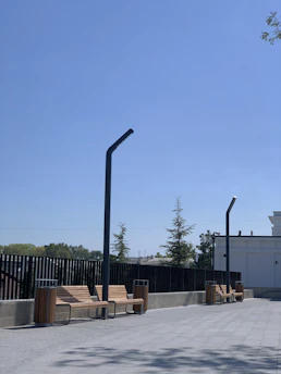 Wide shot of a clean commercial plaza with freshly washed walkways and storefronts gleaming in the sunlight