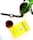A pot with a green plant is placed on a white surface alongside a smartwatch, a glass of tea, and a yellow book titled 'Hooked' by Nir Eyal.