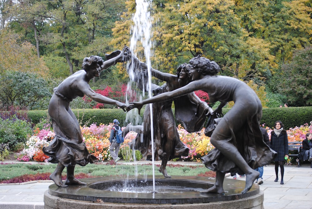 people in black statue fountain during daytime