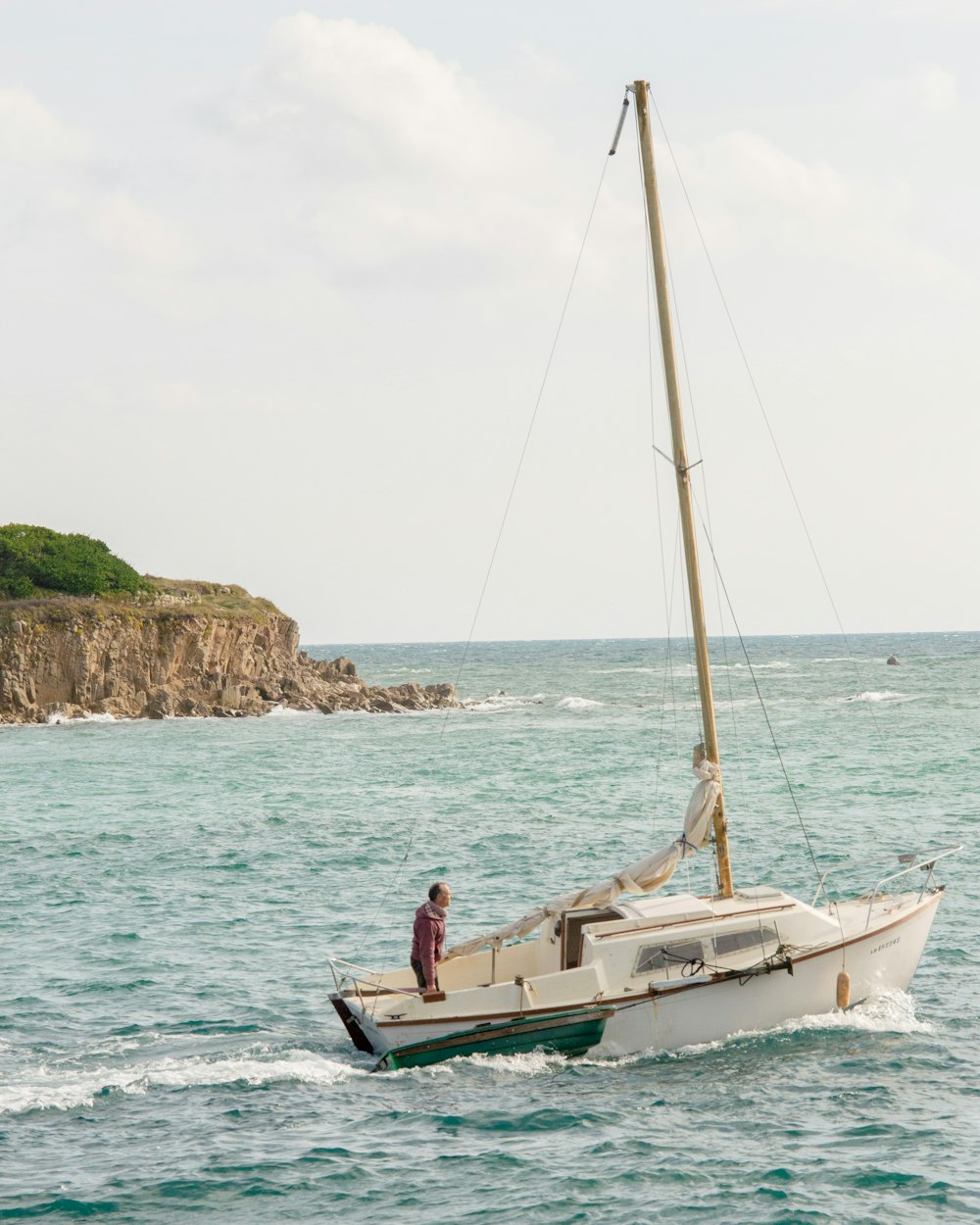 woman in white and black bikini sitting on white boat on sea during daytime