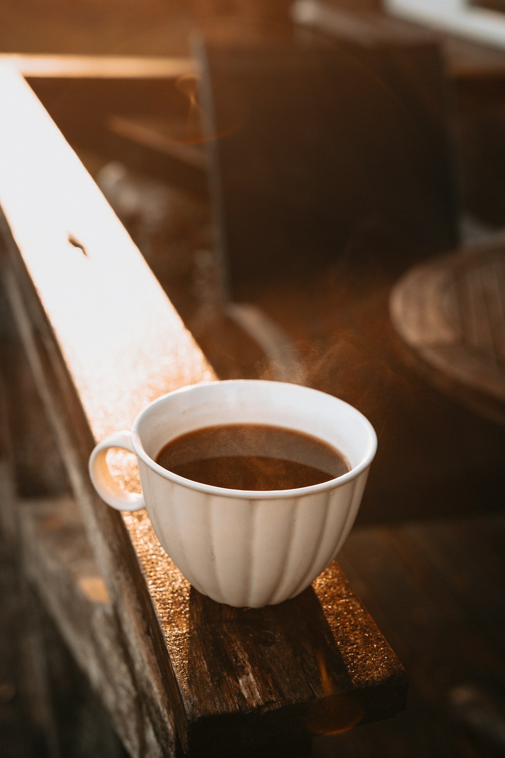 white ceramic mug on brown wooden table