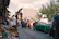 A lively village market scene with stalls full of fresh produce and handmade crafts.