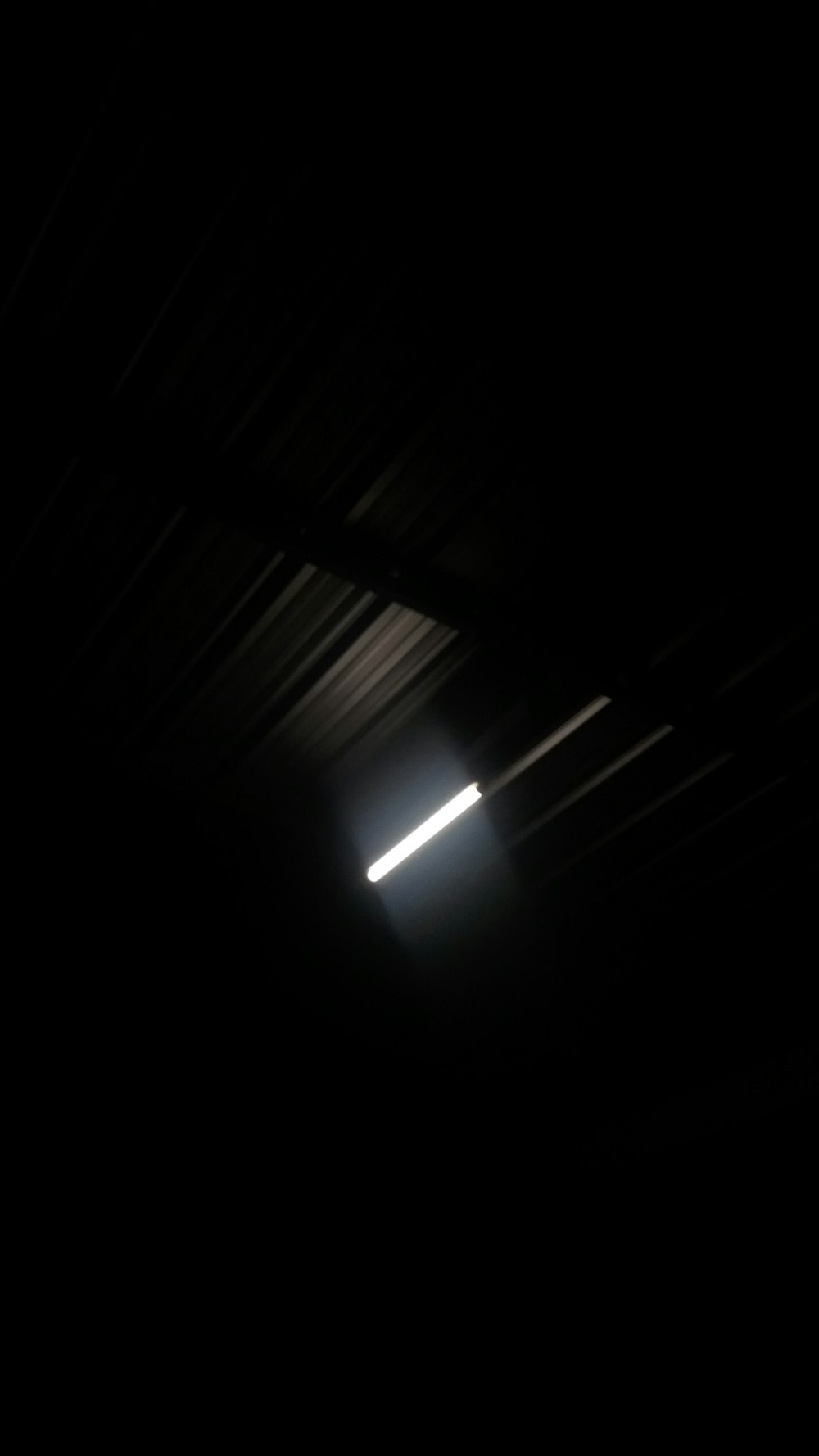 white fluorescent light turned on in dark room