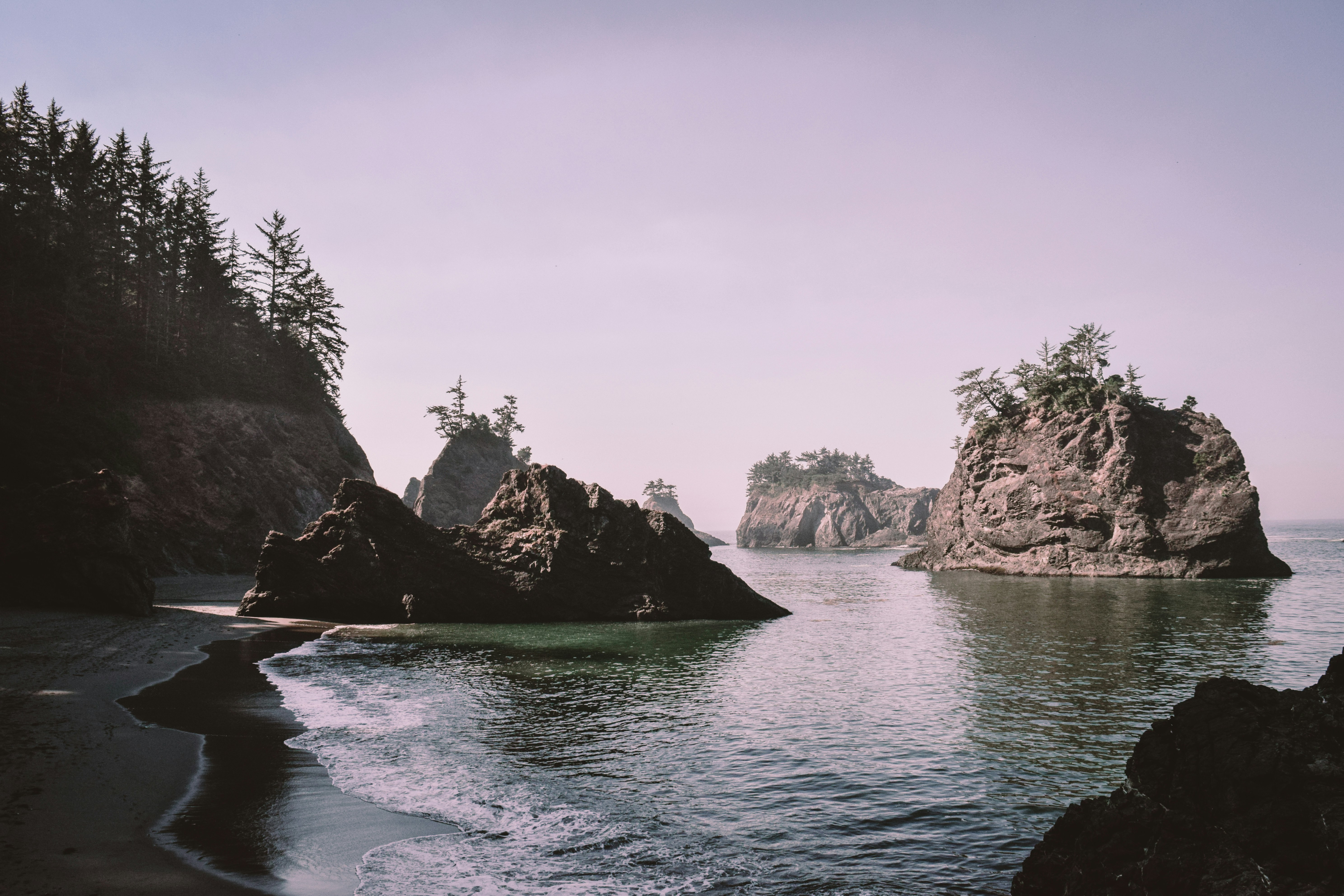 brown rock formation on blue sea under blue sky during daytime