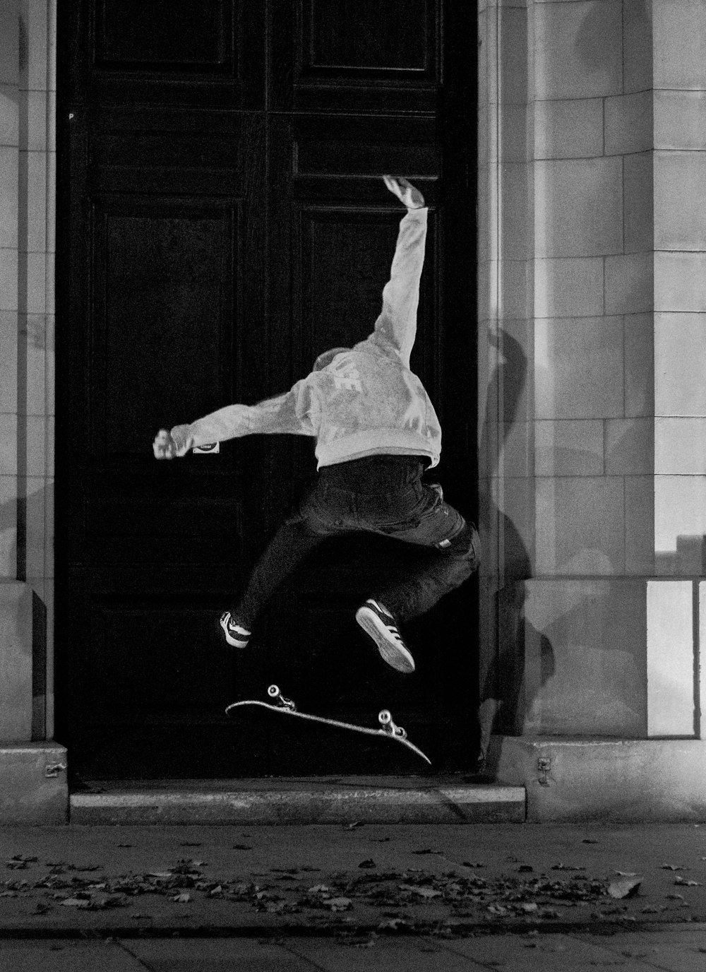 man in white shirt and black pants jumping on the floor