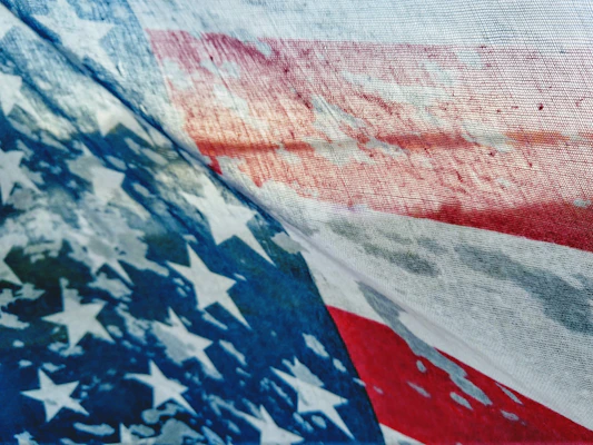 Close-up of a rugged black tee with a bold American flag graphic.