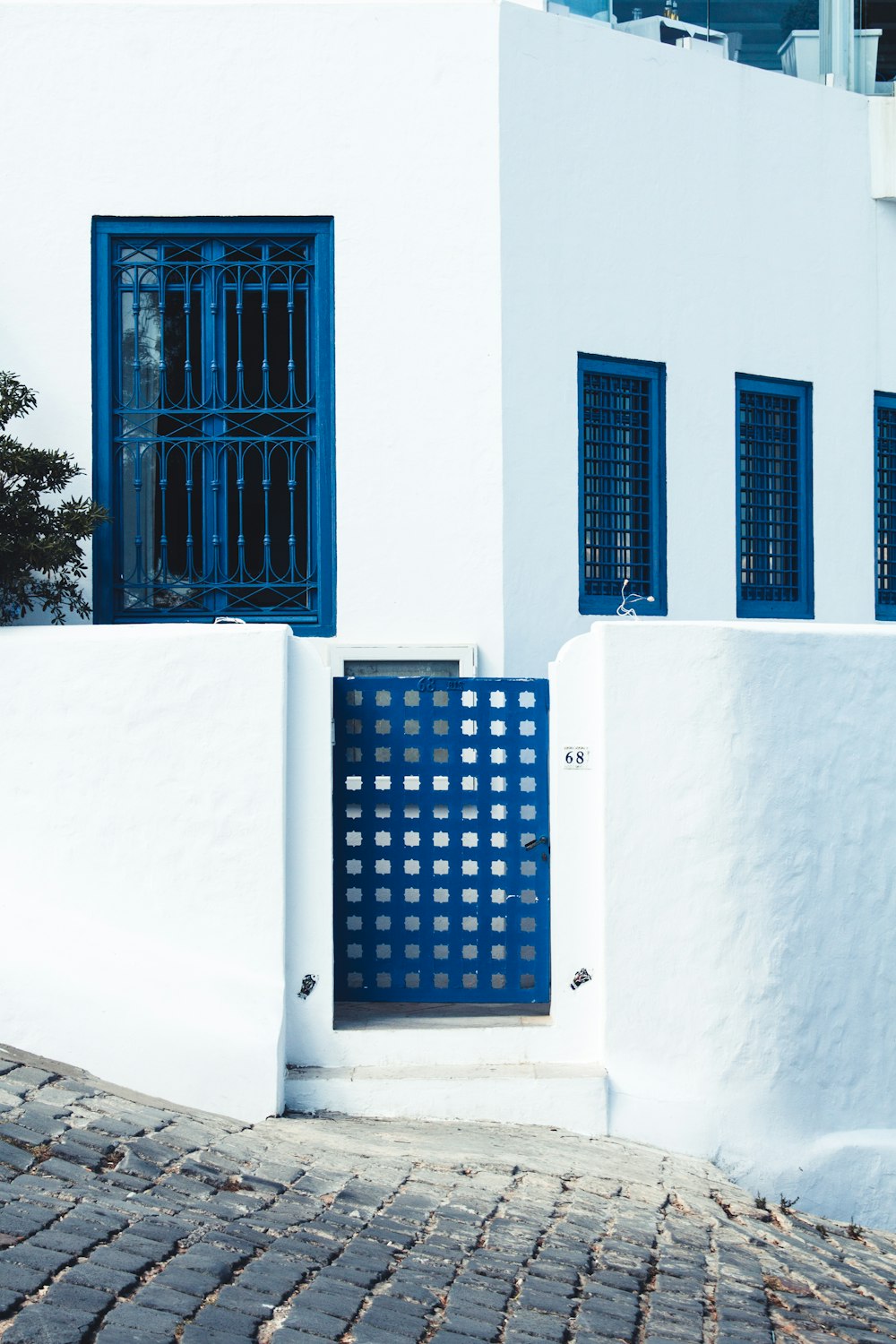 blue wooden door on white concrete wall