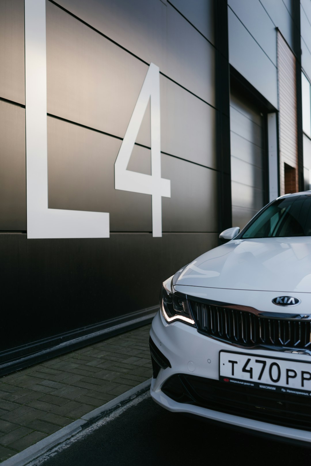 white bmw m 3 parked beside white wall