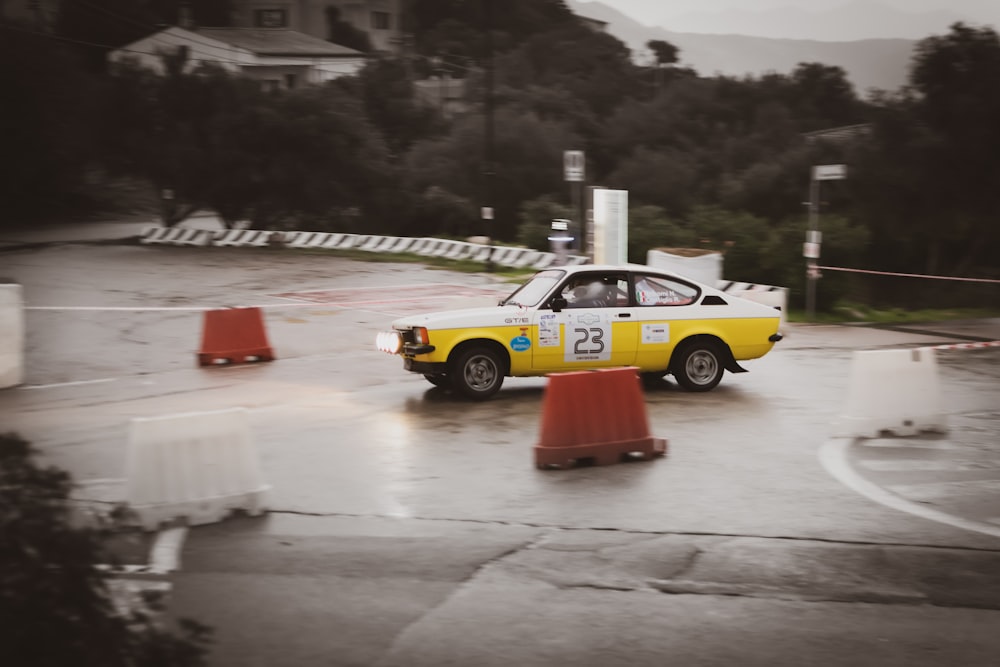 yellow and black racing car on road