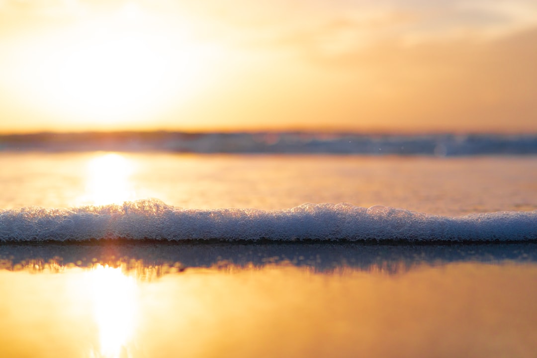 body of water during sunset