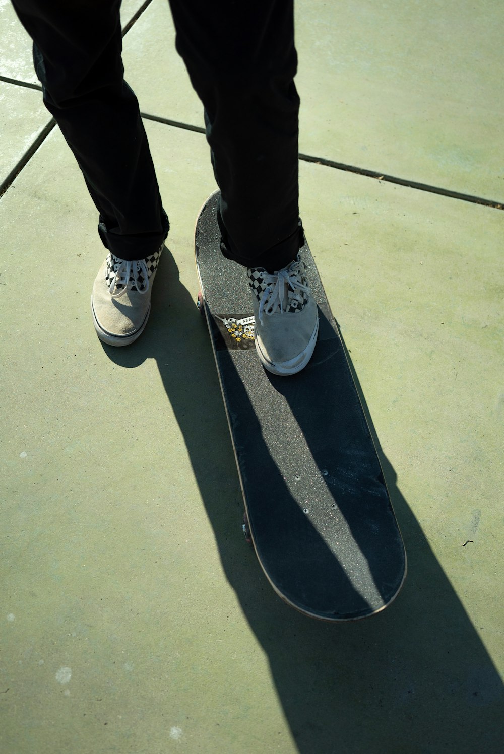 person in black pants and white and blue sneakers