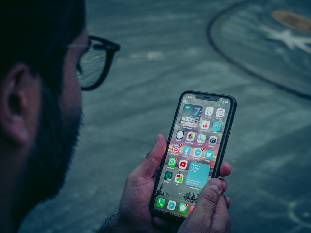 person holding black iphone 5