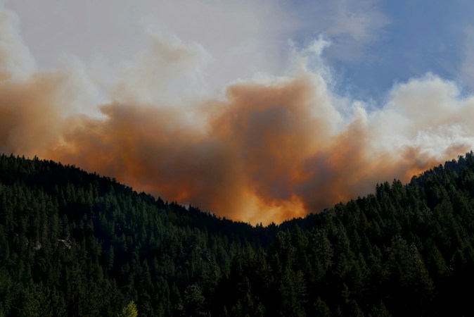 A hazy mountain ridgeline barely visible through drifting wildfire smoke, similar to how the valley's mountain views looked during the advisory