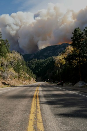 Wildfire smoke rising off a dry hillside, the kind of plume that drifted north into the Las Vegas valley in September 2026
