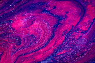 A glowing purple and pink galaxy swirling with stars and digital art elements.