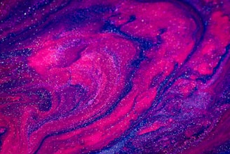 A vibrant galaxy-themed resin art piece featuring bold neon colors swirling together.
