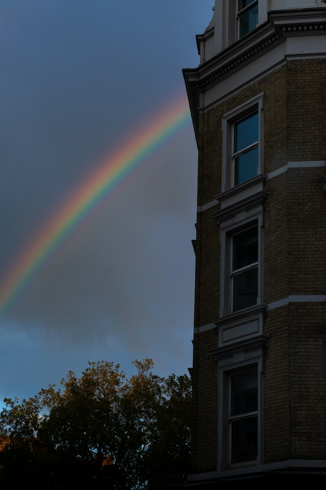 rainbow over brown concrete building