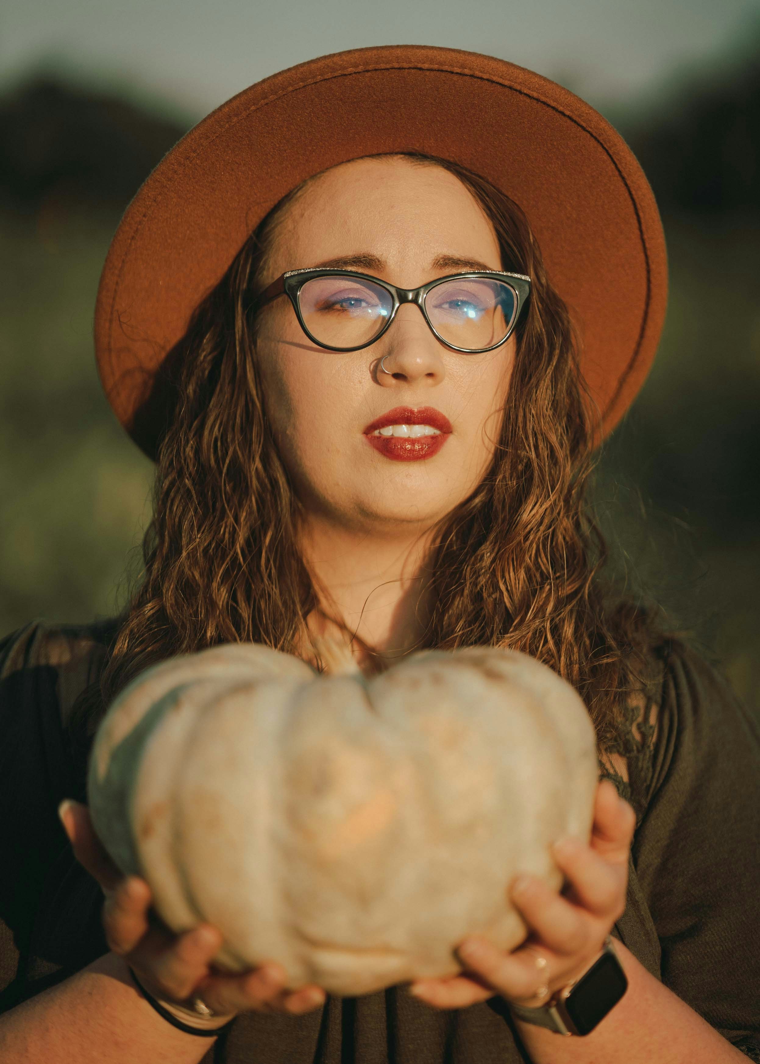 Woman in black framed eyeglasses and brown hat photo Free Ocala Image
