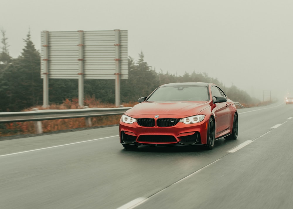 red bmw m 3 on road during daytime