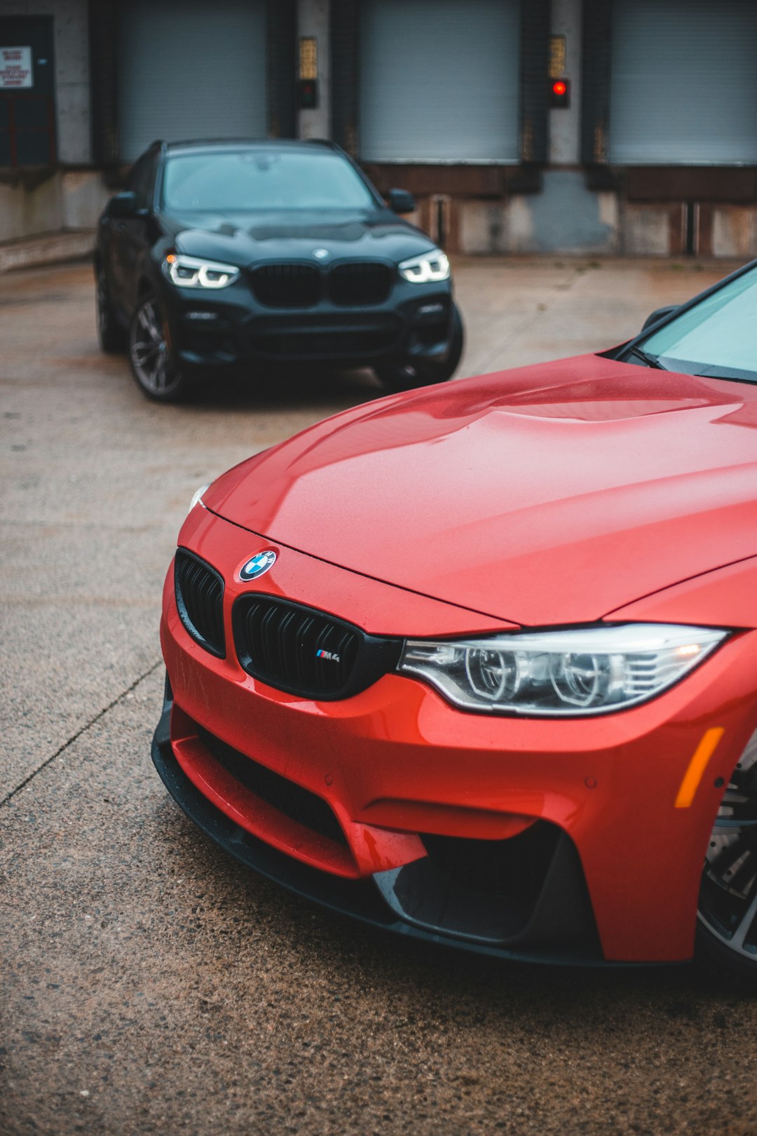 red bmw m 3 parked on gray concrete pavement during daytime