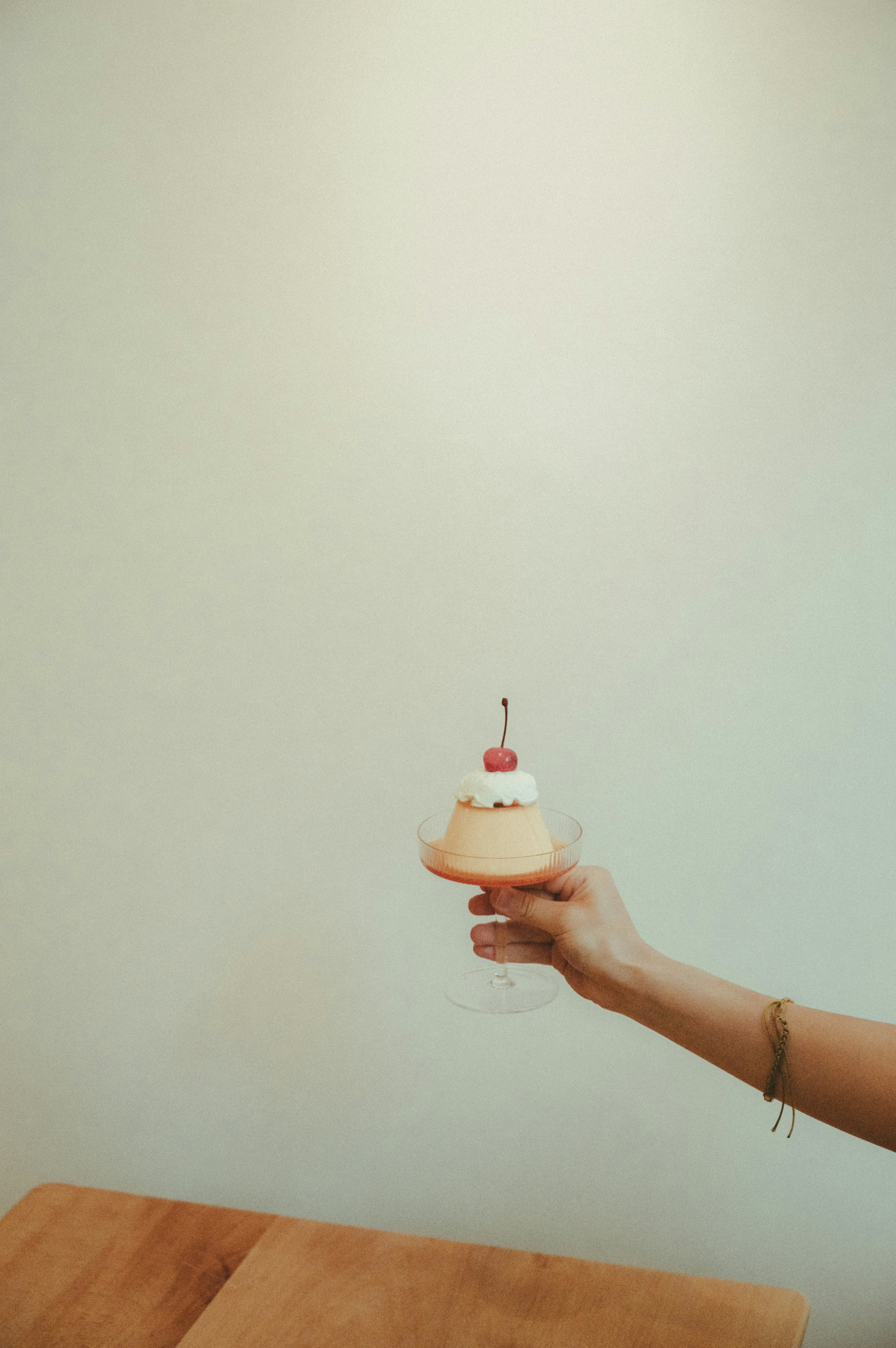 person holding white and pink plastic feeding bottle