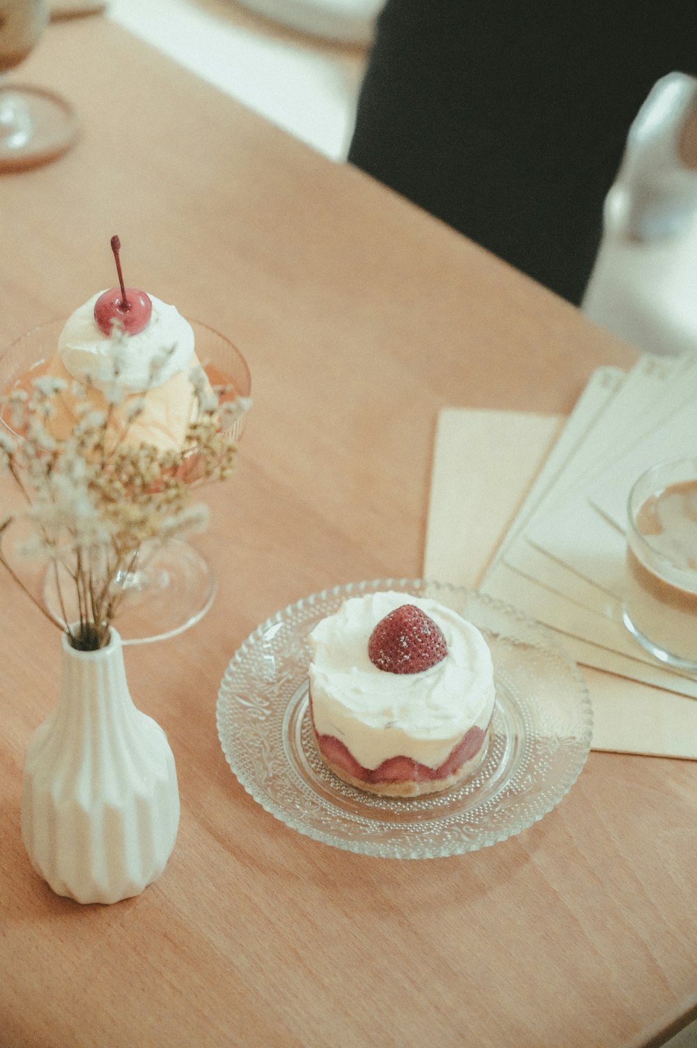 white and red ice cream on clear glass cup on white ceramic saucer