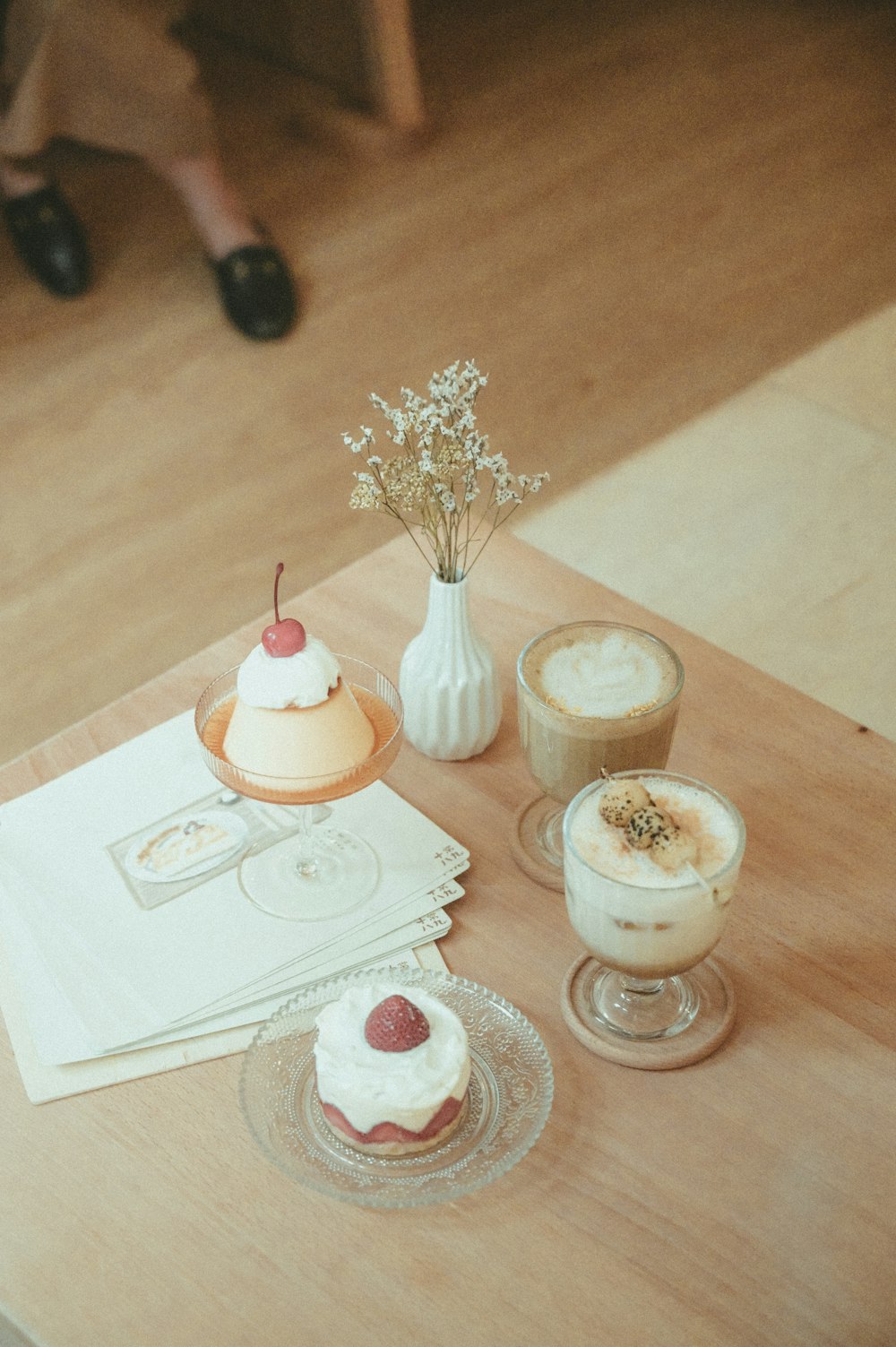 white and pink ice cream on clear glass cup