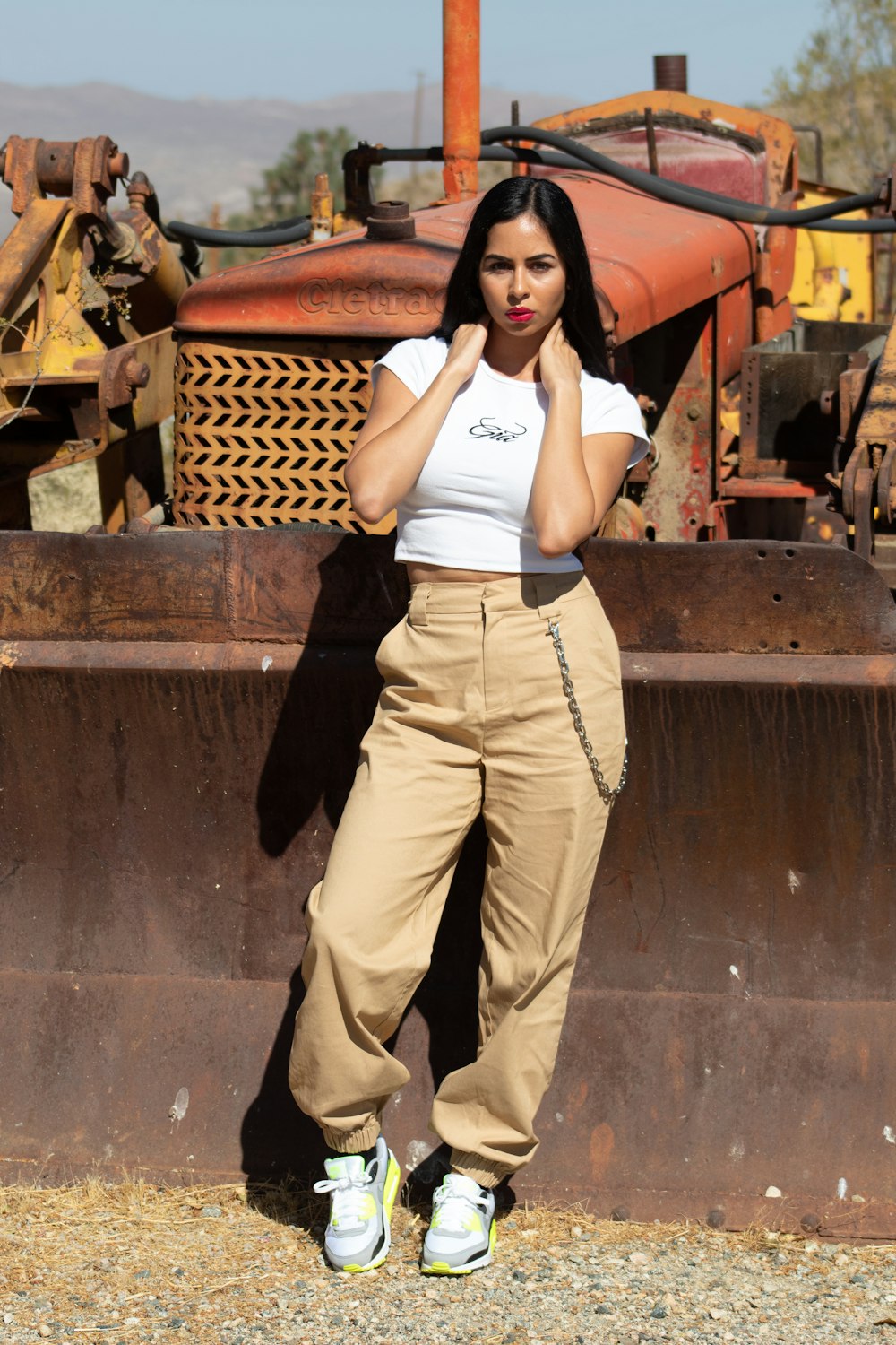 woman in white tank top and brown pants