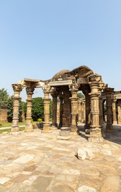 an old stone structure with pillars and pillars