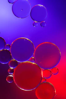 A colorful digital brain composed of interconnected bubbles glowing softly on a dark background.