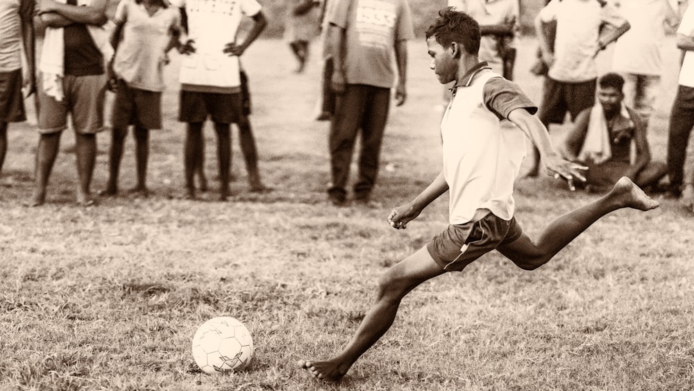 grayscale photo of 2 men playing soccer