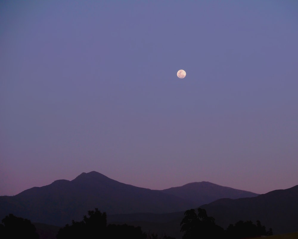 silhouette of mountain during night time