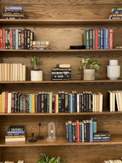 books on brown wooden shelf