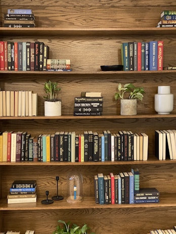 A custom wood bookshelf filled with books and plants, highlighting clean craftsmanship.