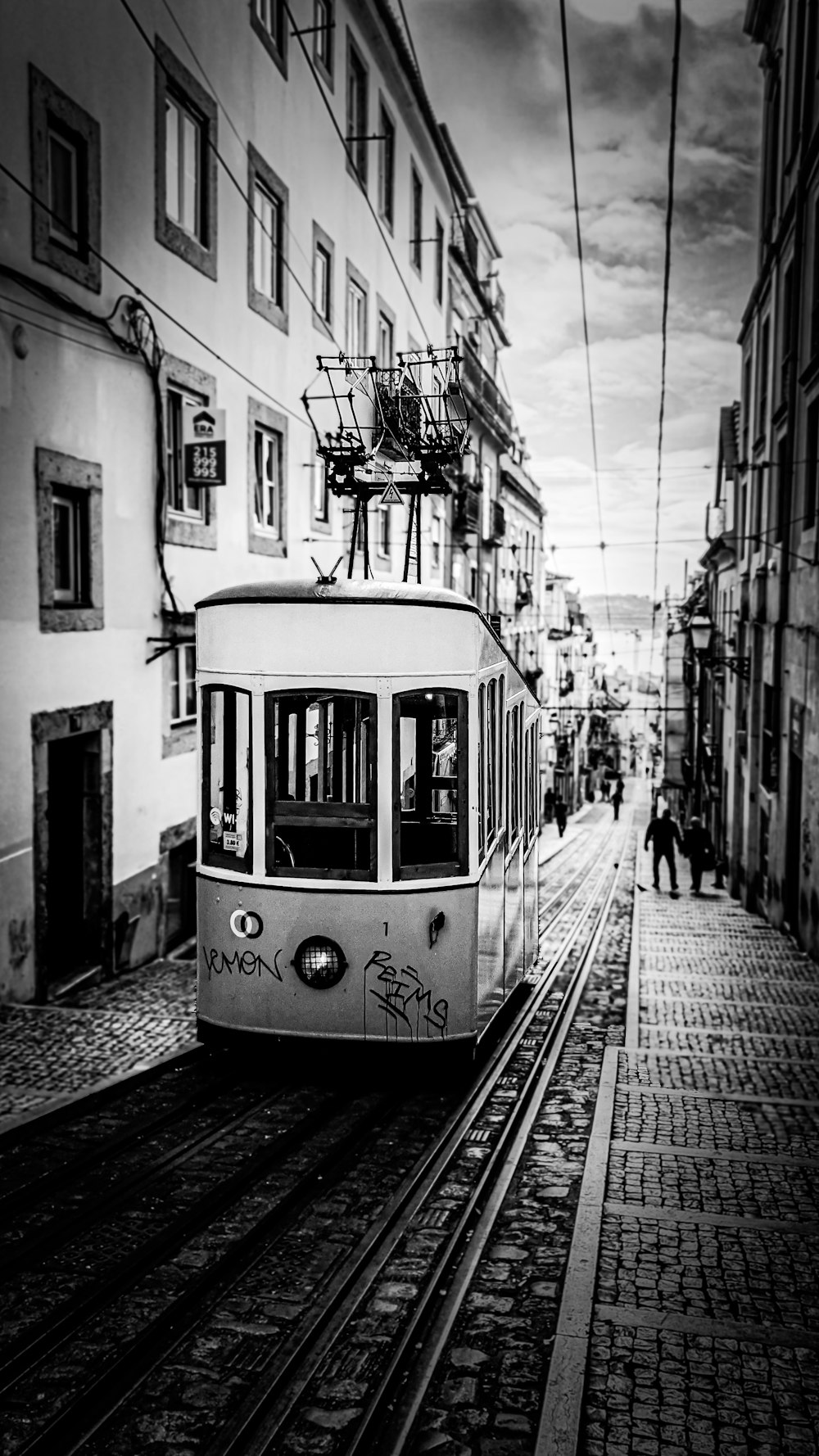 grayscale photo of tram on road