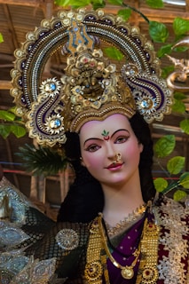 woman in blue and gold floral dress wearing gold crown