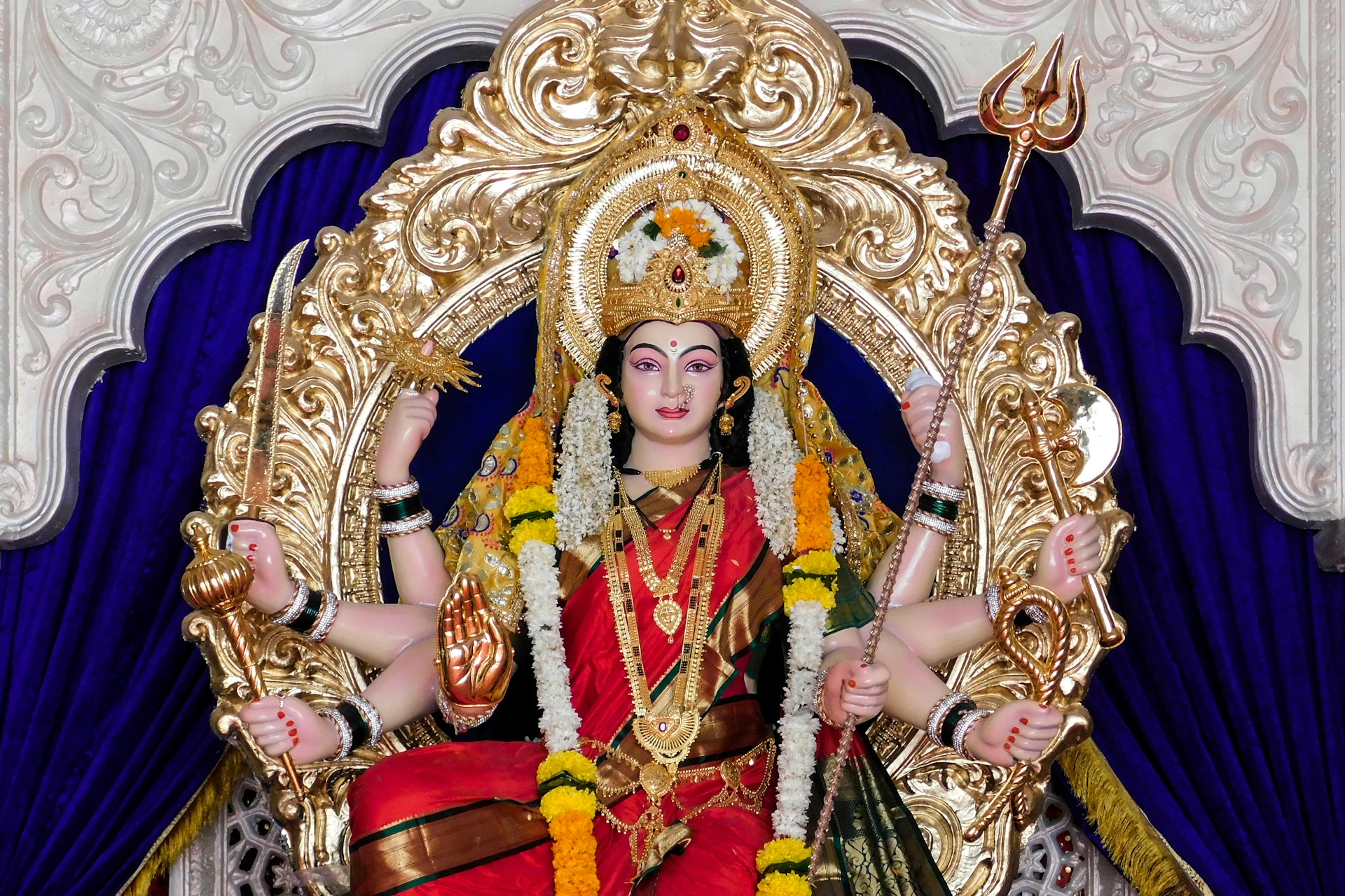 gold and red hindu deity figurine