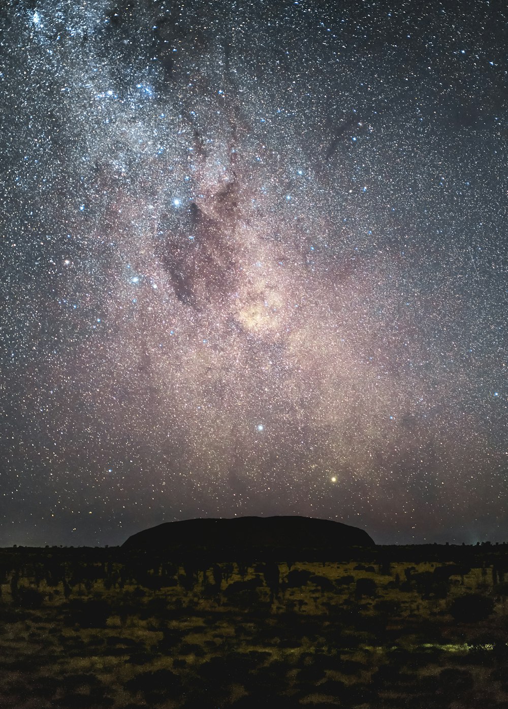 silhouette of mountain under starry night