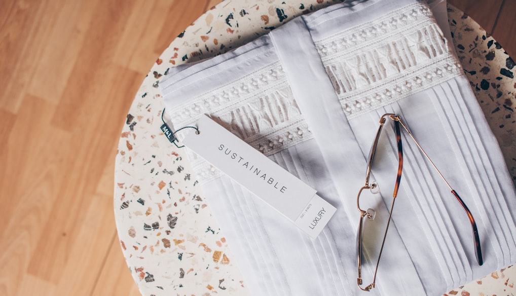 silver framed eyeglasses on white and blue floral textile