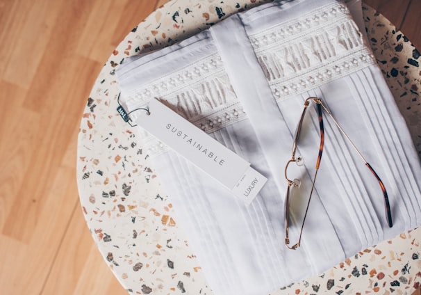 silver framed eyeglasses on white and blue floral textile