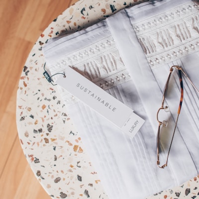 silver framed eyeglasses on white and blue floral textile