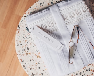 silver framed eyeglasses on white and blue floral textile